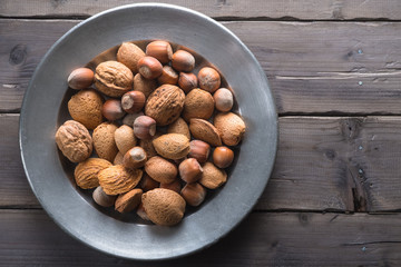 Hazelunts, walnuts and almonds on a pewter plate