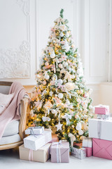 beautiful modern design of the room in delicate light colors decorated with Christmas tree and decorative elements