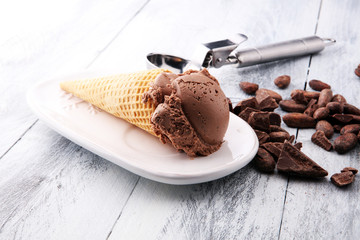 chocolate ice cream scoops with pieces of chocolate and waffle cones