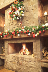 New Year / Christmas tree with colorful festive decorations on the fireplace - 185032221