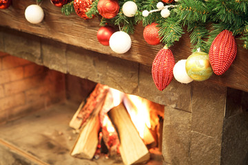 New Year / Christmas tree with colorful festive decorations on the fireplace - 185032240