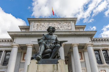  The main entrance to the Prado Museum and the bronze statue of Diego Velazquez in Madrid