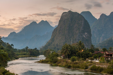 Beautiful sunrise over the Nam Song river near the Vang Vieng village, Laos - obrazy, fototapety, plakaty