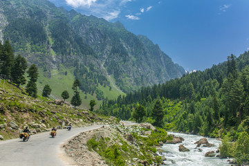 Tourists riding motorbikes in Himalayan mountains on Srinagar - Kargil road in Jammu and Kashmir...