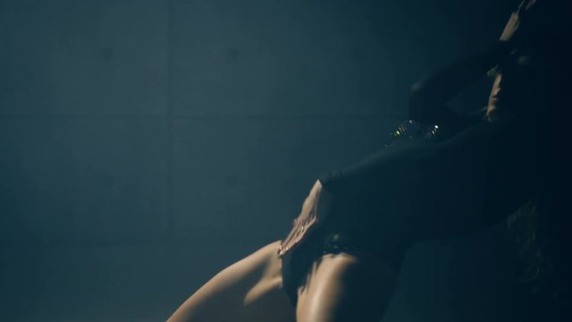 Attractive blonde performing an erotic dance. Slow motion