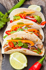 Three mexican tacos with meat and vegetables. Tacos al pastor on