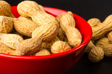 Peanuts in shell on dark background, close up
