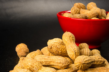 Peanuts in shell on dark background, close up