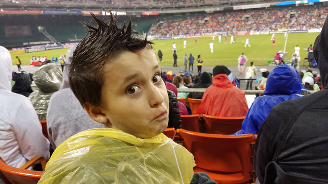 Watching Soccer Game In The Rain