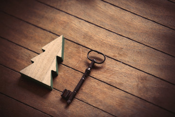 Obraz na płótnie Canvas Christmas tree toy and metal key on wooden background