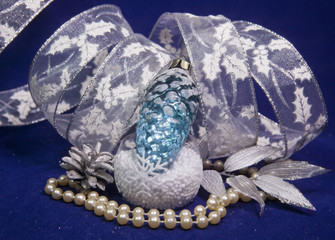 Fototapeta premium The glass New Year's cone and a New Year's tape on a blue background