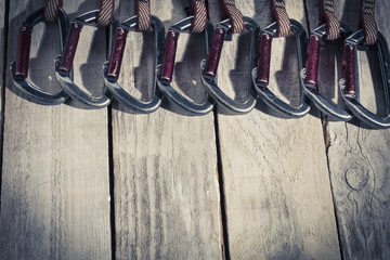 A set of climbing carbines on a wooden table.