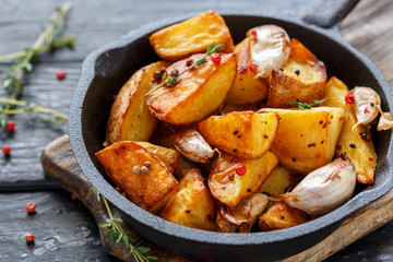 Baked potatoes with garlic and fresh thyme.