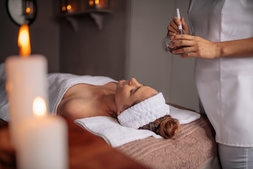 Woman getting a facial treatment at beauty spa