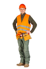 construction worker in a helmet with toolbelt hands on hips in orange security vest