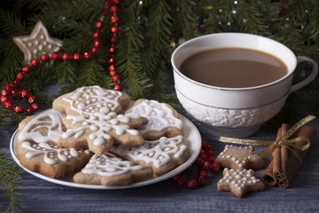 New Year's gingerbreads decorated with icing on a plate and  cup with cacao