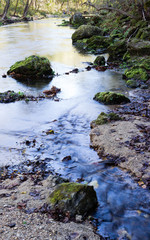 Sunrise over river with rocks