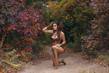 Aggressive-sexual wild girl, wanders in the jungle with a tamed bird. Artistic Photography