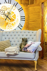 large clock face and sofa in the studio