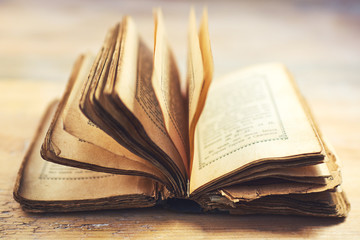 Old Book on wooden table. Selective focus.