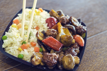 A mixture of Chinese food with rice and peanuts