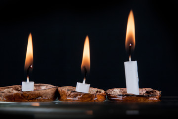 Christmas candles in walnut shell on water surface