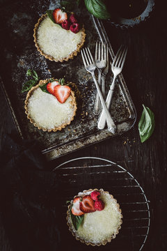 Freshly baked mini lemon tarts with strawberries