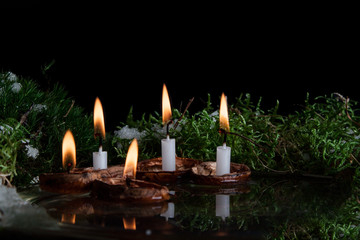 Christmas candles in walnut shell on water surface