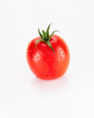 A washed bright red ripe chilled plum tomato isolated on a white