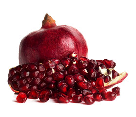 grains of pomegranate on the background of whole fruit