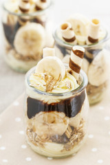 Layer dessert with muesli, chocolate and banana fruits.