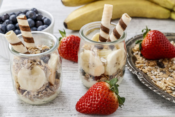 Layer dessert with muesli, chocolate and banana fruits.