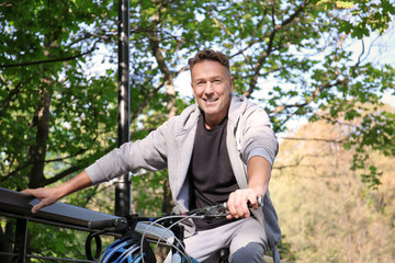 Fototapeta na wymiar Mature sporty man with bicycle outdoors
