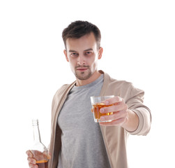 Drunk man with bottle and glass of whiskey on white background. Alcoholism concept