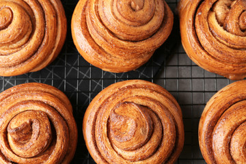 Cooling rack with sweet cinnamon rolls on table