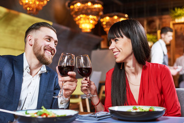 young man and woman celebrating in restaurant