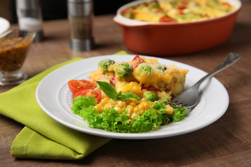 Plate of tasty baked Brussels sprouts with cheese on table