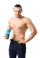 Fototapeta na wymiar Muscular young bodybuilder with bottle of protein cocktail on white background