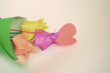 Multicolored tulips handmade from paper by March 8 on a light background.
