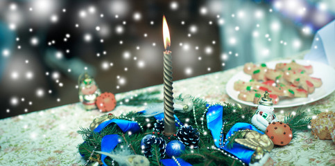 candle,Christmas wreath and decorations on holiday table