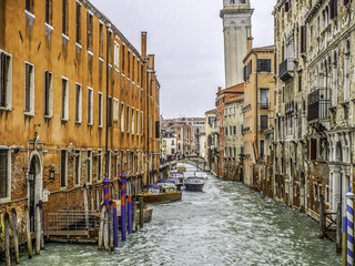 Fototapeta na wymiar Sidestreet canal in Venice during a November rainstorm