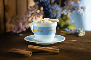 A cup of coffee and cinnamon sticks