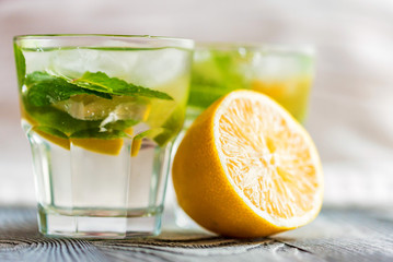 Lemonade or mojito cocktail with lemon and mint