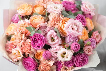 beautiful luxury bouquet of mixed flowers in woman hand. the work of the florist at a flower shop.