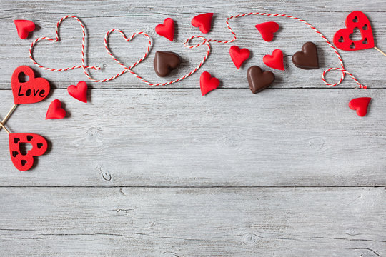 Wooden background with red hearts for Valentines Day