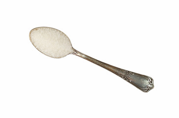 Vintage metal spoon full of white sugar isolated