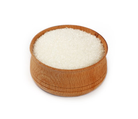 Close up wooden bowl full of white sugar isolated