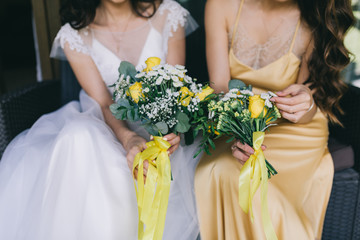 Bride holding yellow bouquet on the wedding.