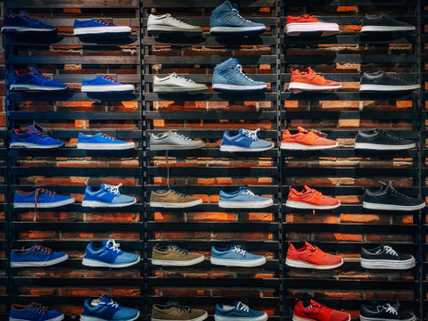 Lots of different sneakers on the showcase on market. Image of sport shoes on shop-window