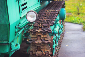 Obraz na płótnie Canvas muddy agricultural tractor wheels with steel tracks in mud